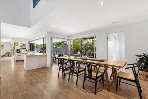 a kitchen and dining room with a table and chairs at Zinc Casuarina in Casuarina