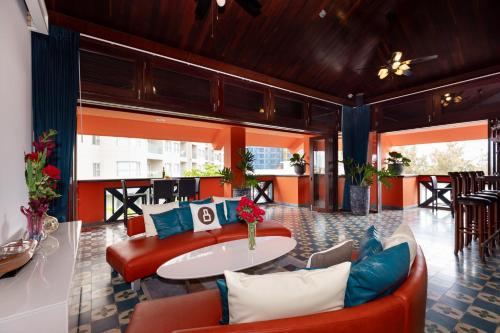 a lobby with a couch and a table and chairs at OrangeBlue villa near Beach Pool free Vung Tau Vietnam in Vung Tau
