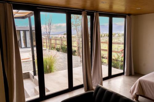 um quarto com uma grande janela com vista em MiLu em El Porvenir