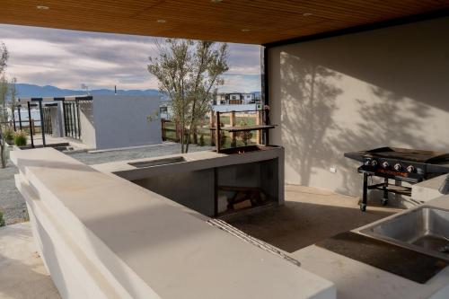 an outdoor kitchen with a counter and a grill at MiLu in El Porvenir