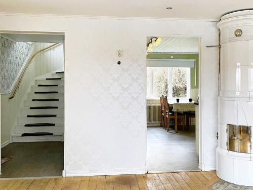 a door leading to a dining room with a staircase at 8 person holiday home in ANNEBY-By Traum in Aneby