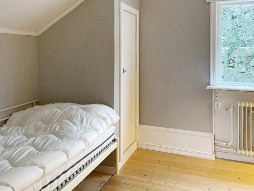 an empty bed in a room with a window at 8 person holiday home in ANNEBY-By Traum in Aneby