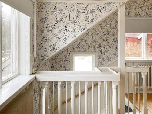 a staircase in a house with a wallpaper at Holiday home ANNEBY II in Aneby