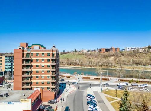 a view of a city with a river and buildings at Lovely lake view apartment downtown Calgary one bedroom fully furnished in Calgary