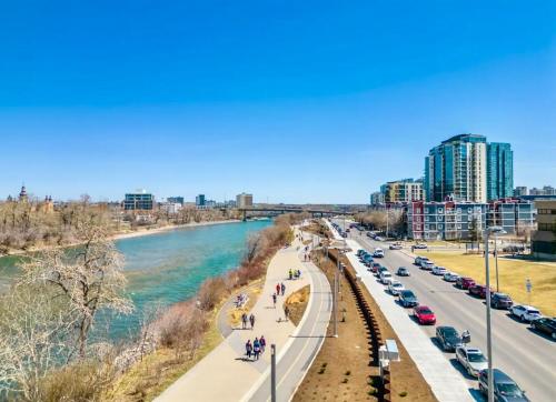 a bridge over a river with cars on it at Lovely lake view apartment downtown Calgary one bedroom fully furnished in Calgary