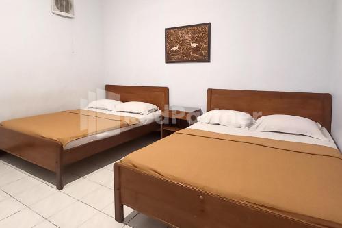 Postel nebo postele na pokoji v ubytování Hotel Palem 1 Syariah RedPartner