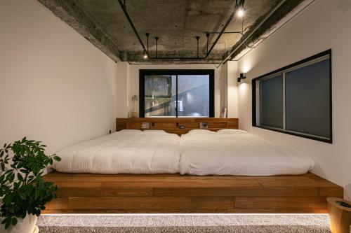 a large bed in a room with a large window at City Center Villas ゲストハウス35 supported by COCOSTAY in Hijiyamachō