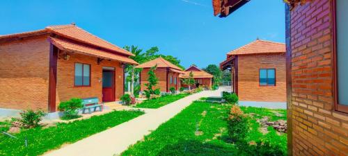 a row of brick houses with a pathway at Hương Rừng Nam Cát Tiên in Tân Phú