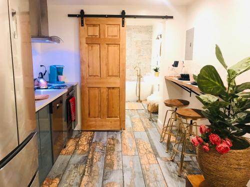 a kitchen with a wooden door and a counter at Luxury City Tiny House in Denver