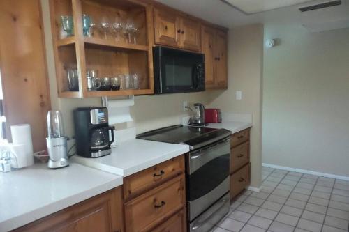 a kitchen with wooden cabinets and a stove top oven at Water Front Sweet Home in Mesa