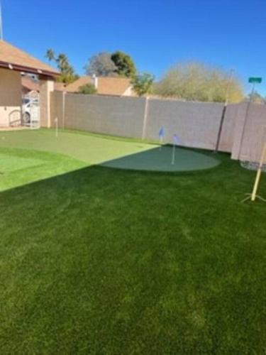a green yard with a golforie in the grass at Water Front Sweet Home in Mesa