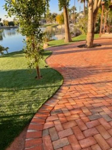 a brick walkway next to a body of water at Water Front Sweet Home in Mesa