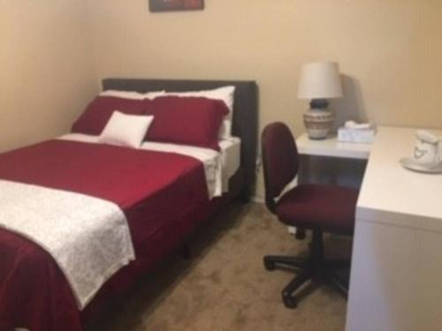 a bedroom with a bed and a desk and a chair at Water Front Sweet Home in Mesa