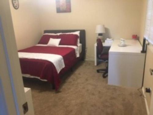 a bedroom with a bed and a desk with a chair at Water Front Sweet Home in Mesa