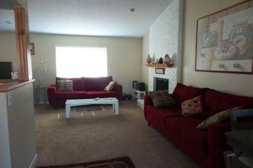 a living room with a red couch and a table at Water Front Sweet Home in Mesa