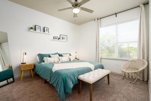 a bedroom with a bed and a ceiling fan at Alamo Chic King Bed Refreshing Office Desk w/ Pool in San Antonio