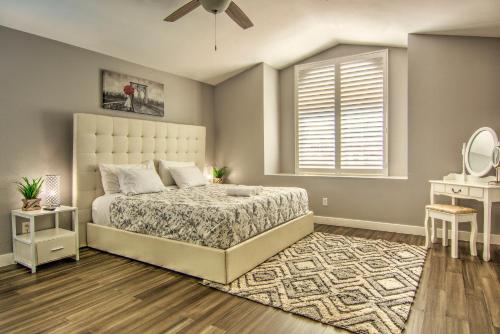 a bedroom with a large bed and a window at HOUSE VEGAS in Las Vegas