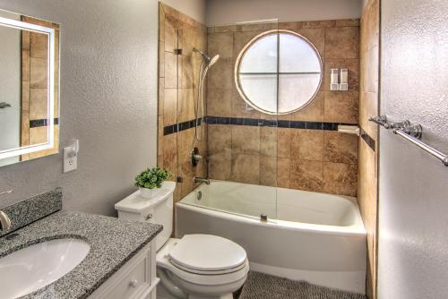 a bathroom with a toilet and a tub and a sink at HOUSE VEGAS in Las Vegas