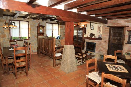 a living room with wooden furniture and a fireplace at Gane Landetxea in Barrika