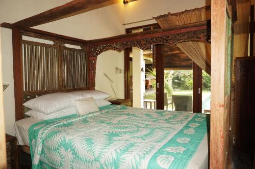 a bedroom with a bed with a canopy at Villa Mangga in Ubud