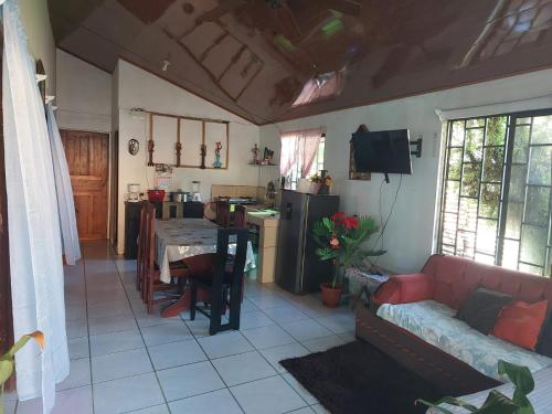 a living room with a couch and a table at Tortuguero family house hostel in Tortuguero