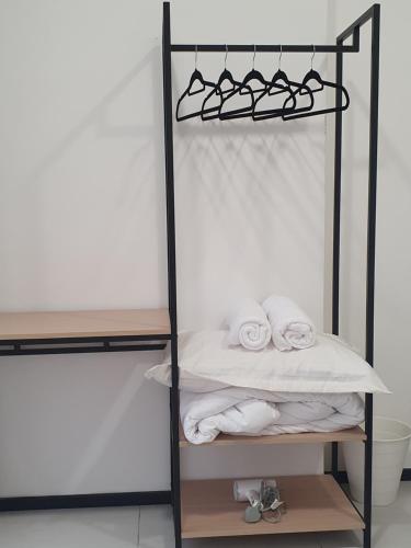 a towel rack with towels in a bathroom at Seaview Infinity Retreat Urban Suite 3R2B 8Pax Georgetown in Jelutong