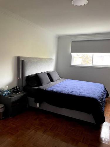 a bedroom with a large bed with a window at Modern, Spacious & Great Location Home in Mississauga