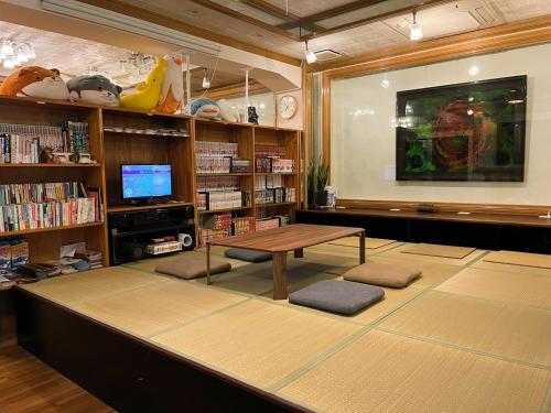 Una televisión o centro de entretenimiento en Guest House Umikaji