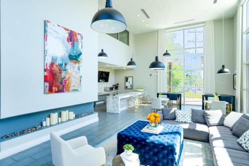 a living room with a couch and a table at Alamo Chic King Bed Refreshing Office Desk w/ Pool in San Antonio