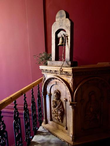 a wooden altar with a statue next to a staircase at VASILIKON Hotel 1888 the past is present HISTORICAL PRESERVATION MONUMENT in Kalamata