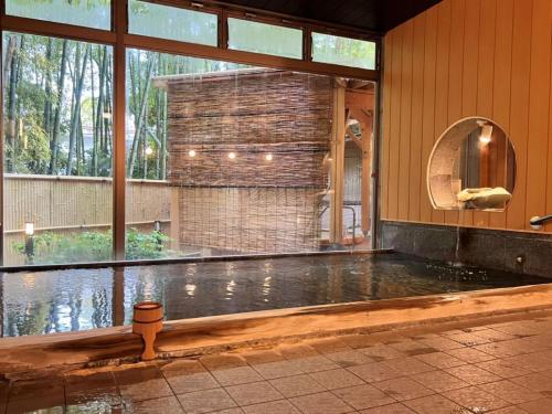 a pool of water in a room with a large window at Mizunoto Reopening on April 1, 2025 in Hakone