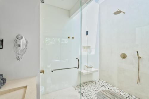 a shower with a glass door in a bathroom at Pagi Villas by Betterplace in Canggu