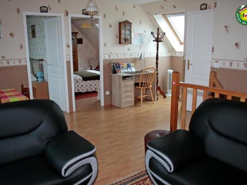 - un salon avec deux chaises et un bureau dans l'établissement Charmant gîte familial à Fiennes, 2 chambres, jardin privé, terrasse, proche Wissant, animaux acceptés - FR-1-376-118, à Fiennes