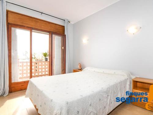 - une chambre avec un grand lit et une grande fenêtre dans l'établissement Apartamento Roda de Berà, 3 dormitorios, 6 personas - ES-320-5, à Roda de Bará