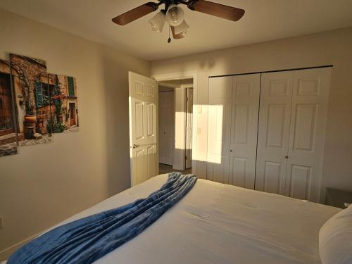 a bedroom with a bed with a ceiling fan at La Dolce Vita B and B in Osoyoos