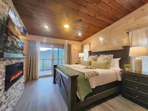 a bedroom with a large bed and a fireplace at A Splashing Good Time in Sevierville