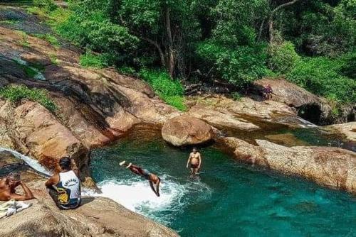 a group of people swimming in a river at Abimansala Resort in Hunnasgiriya