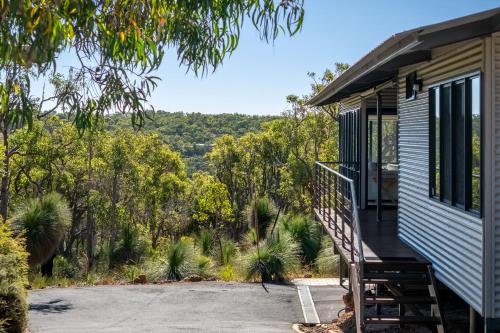a tiny house with a porch and a staircase at Matilda I Private Properties in Dunsborough