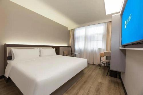 Voodi või voodid majutusasutuse Hanting Hotel Shanghai North Bund Kongjiang Road toas