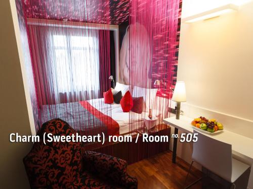 a room with a bed and a table with a bowl of fruit at Bohem Art Hotel in Budapest