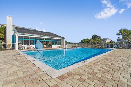 a swimming pool in front of a building at Calatrava Beach Cottage Pet Family Friendly in Destin