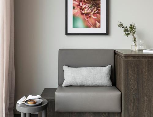 a chair in a room with a picture on the wall at Oakwood Premier Melbourne in Melbourne