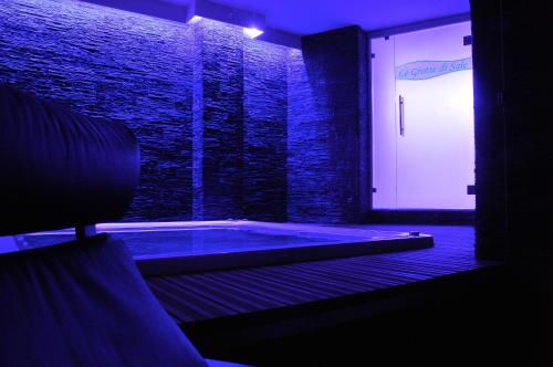 a dark room with a jacuzzi tub in a building at Jolly Resort & Spa in Ponte di Legno