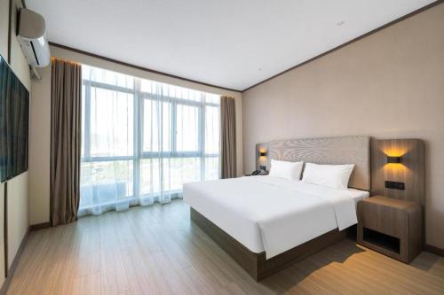 Kama o mga kama sa kuwarto sa Hanting Hotel Putian Hanjiang