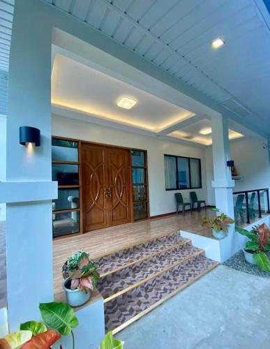 a lobby with a wooden floor and a wooden door at Casa Darcera in Dipolog