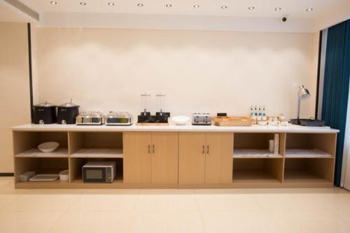a kitchen with a counter with some appliances on it at City Comfort Inn Luzhou Jiangyang District Wancheng International in Luzhou