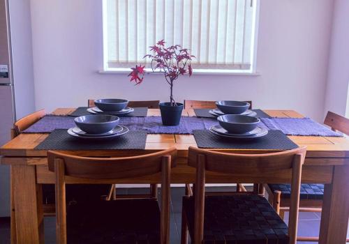 a wooden table with bowls and plates on it at City Vibes Getaway in Leeds