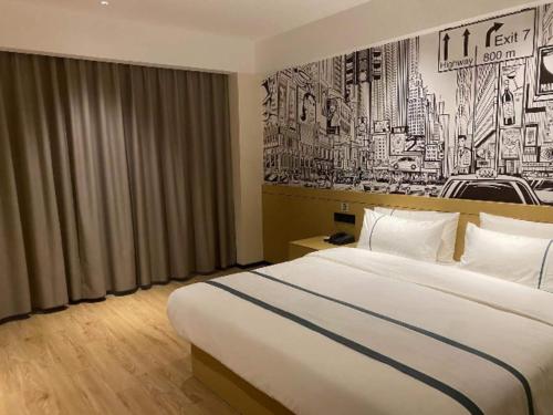 a hotel room with a large bed and a mural at City Comfort Inn Baise High-speed Railway Station Exit in Baise