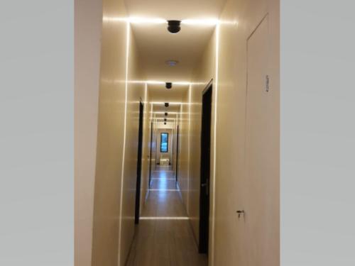 a hallway with a long corridor with a hallway at Airport Hotel in Karanganyar