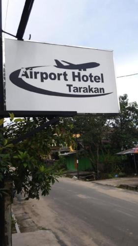 a sign for an airport hotel takasaki at Airport Hotel in Karanganyar